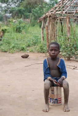 Young boy living in a makeshift community of people internally displaced by the LRA. The settlement is within sight of a multi-million dollar stadium being built for the 5-year anniversary of Sudan's landmark peace agreement. (Enough/Laura Heaton)