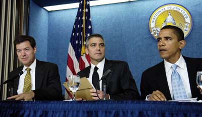 George Clooney is flanked by then-Senator Barack Obama (D-IL) and Senator Sam Brownback (R-KS) at a news conference on Darfur in 2006. (AP)