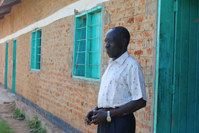 Mr. Bebe looks across the schoolyard at Yei Day Secondary School (Enough/Laura Heaton)
