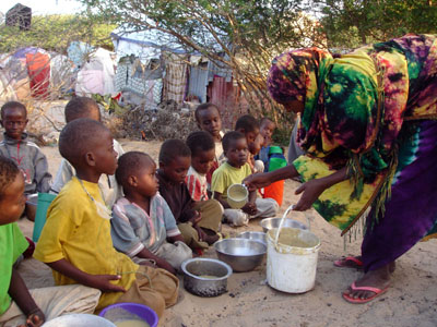 Displaced children receive food in a camp outside of Mogadishu, Somalia. (AP/Farah Abdi Warsameh)