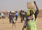Sudanese woman carrying water Sudanese woman carrying water