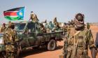 A South Sudanese government soldier stands with others in Bentiu. A South Sudanese government soldier stands with others in Bentiu.