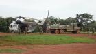 Ugandan soldiers load supplies onto helicopters. 